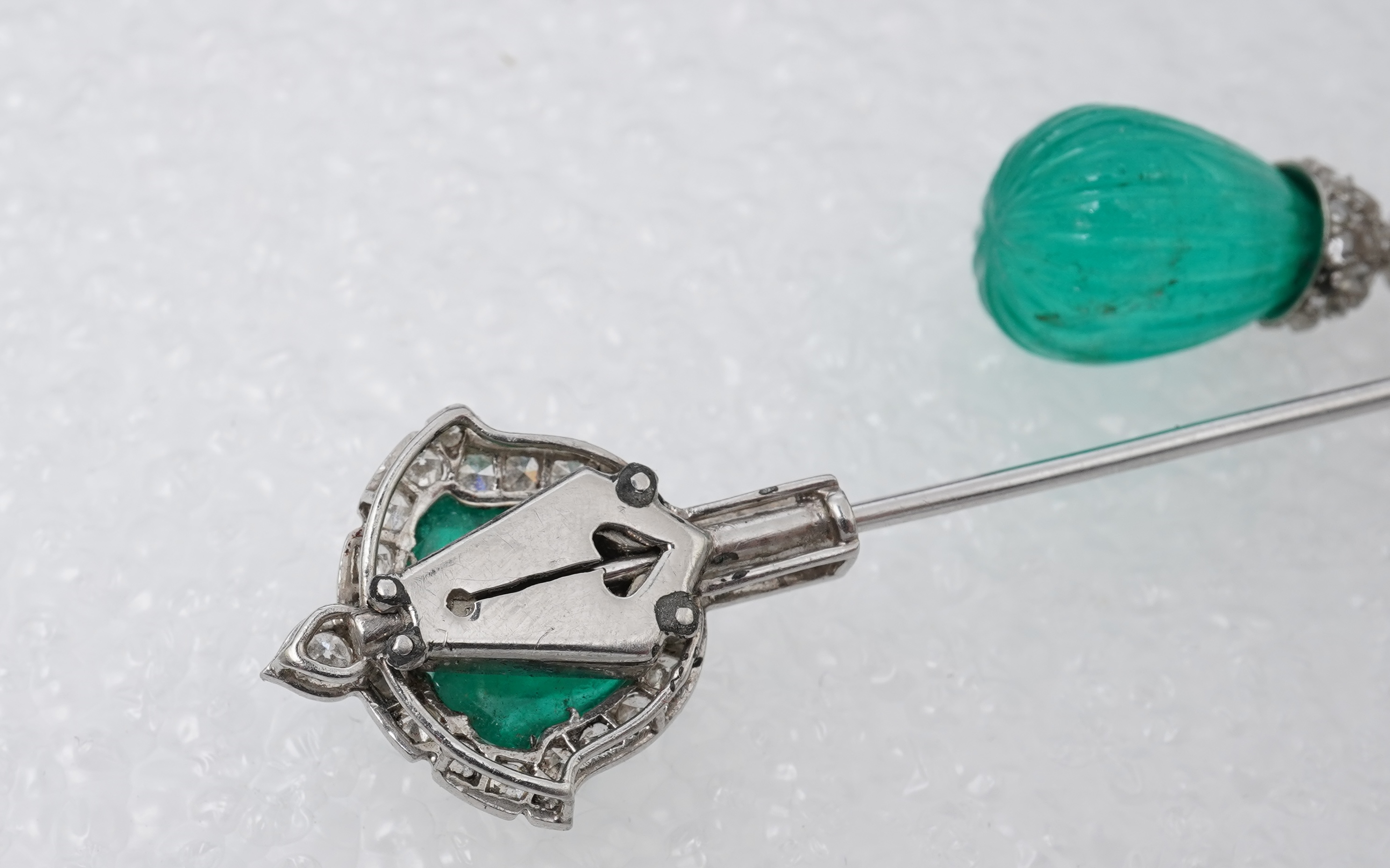 A fine Art Deco carved emerald and diamond jabot pin, circa 1925